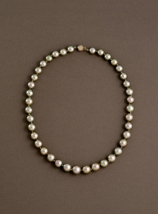Pearl necklace on a brown background